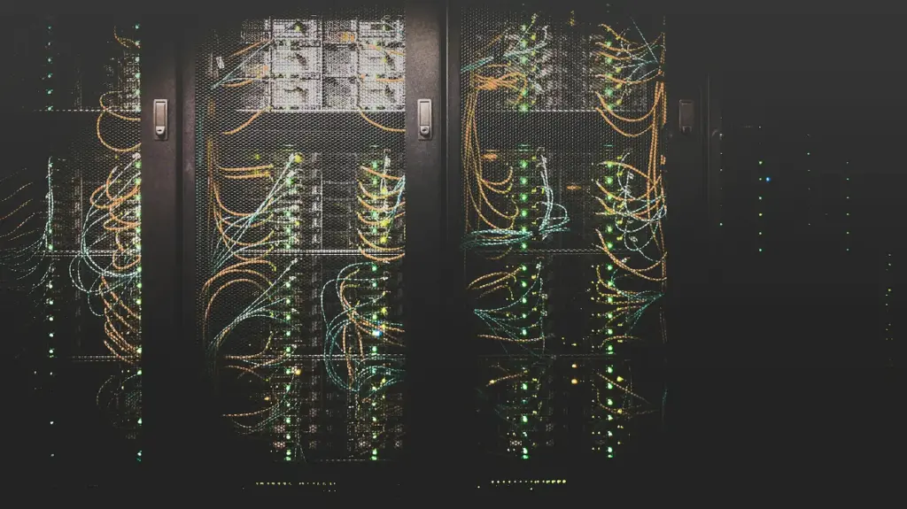 Server racks filled with network cables and blinking lights in a data center.